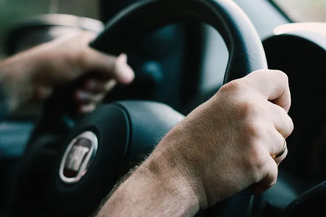 Close-up of hands holding a steering wheel